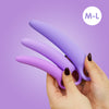 3 Dilators, sized M-L shown on a purple background held up in female hands with dark nail polish